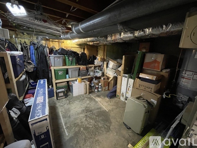 A cluttered garage with various items and boxes scattered about.