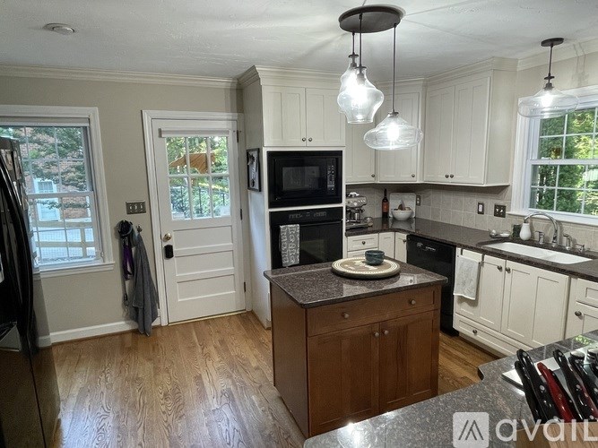 A kitchen with wooden cabinets and a granite countertop.