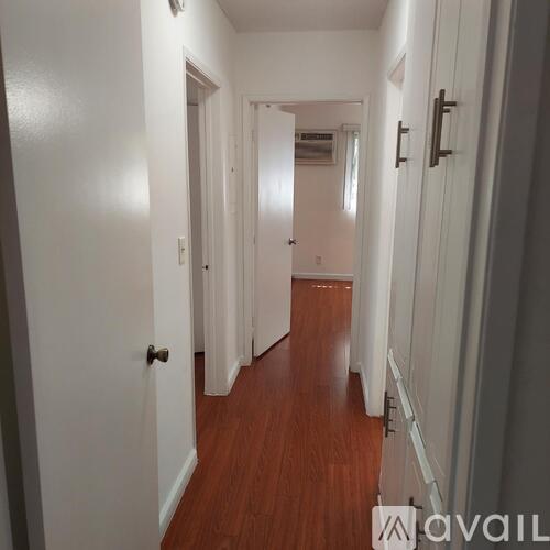 A room with a wooden floor and white walls.