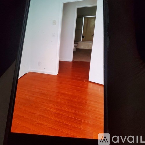 A room with a wooden floor and white walls.