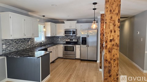 A kitchen with granite countertops and stainless steel appliances.