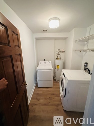 A small laundry room with a washer and dryer.