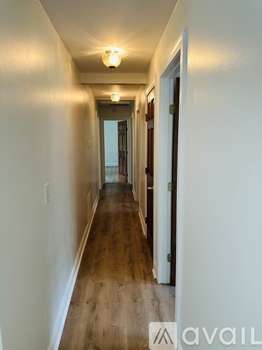 A long hallway with a door at the end.