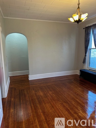 A room with wooden floors and a chandelier.