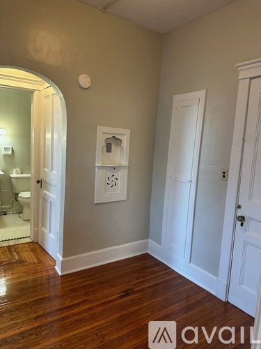 A room with a wooden floor and white doors.