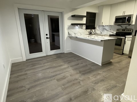 A kitchen with a marble countertop and a stove top oven.