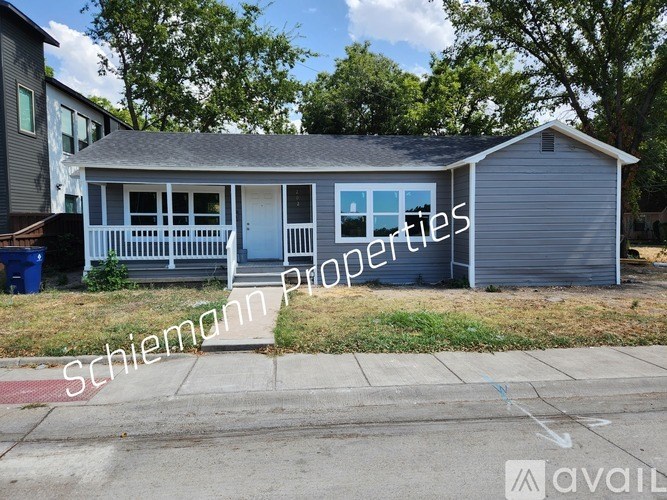 A house with a Schiemann Properties sign in front of it.