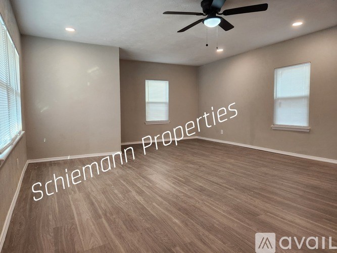 A room with a ceiling fan and wooden flooring is available for rent.