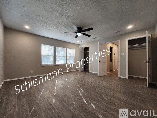 A room with a ceiling fan and wooden flooring is available for rent.