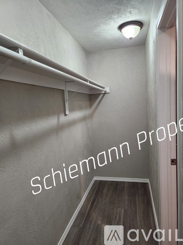 A hallway with a sign that says "Schiemann Property" on the wall.