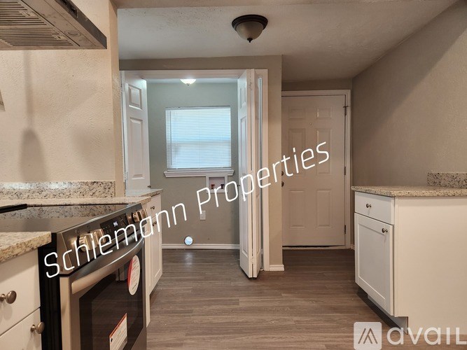 A kitchen with a Schlemann Properties sign.