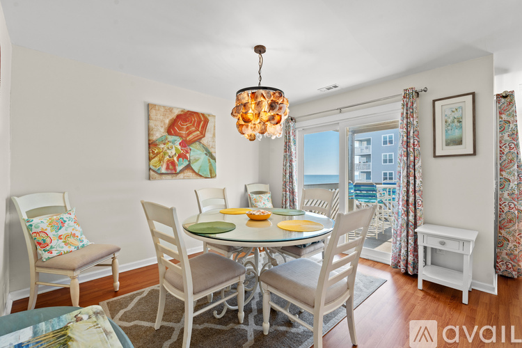 A dining room with a table set for four.