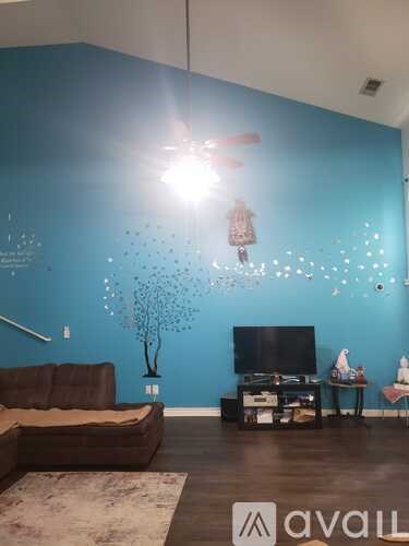 A living room with a brown couch and a television.