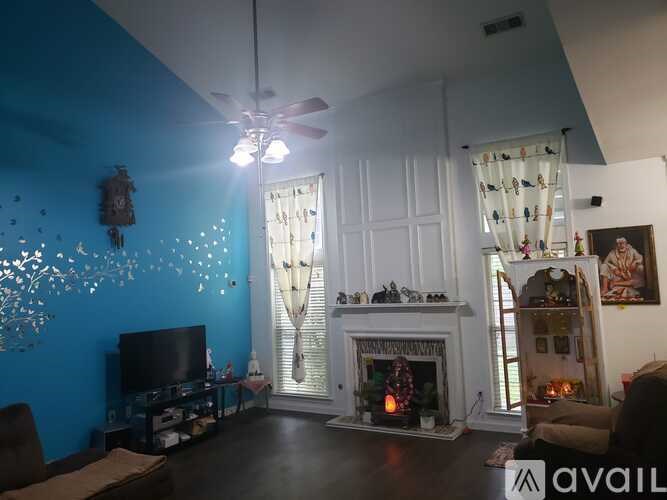 A living room with a fireplace and a television.