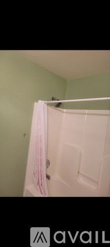 A white door with a pink towel hanging on it.