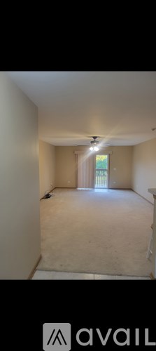 A room with a window and a door is available for rent.