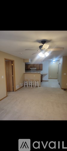 A room with a ceiling fan and a light fixture.