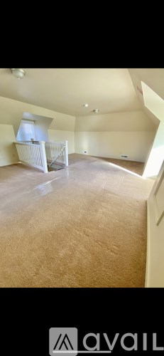 A room with a carpeted floor and a white crib.