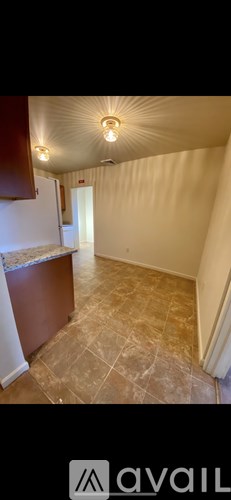 A room with a tiled floor and a wooden cabinet.