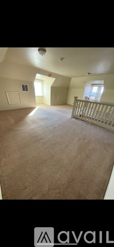 A room with a carpeted floor and a window.