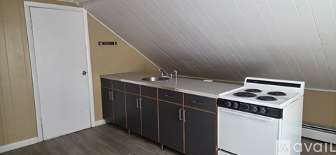 A kitchen with a stove and cabinets.