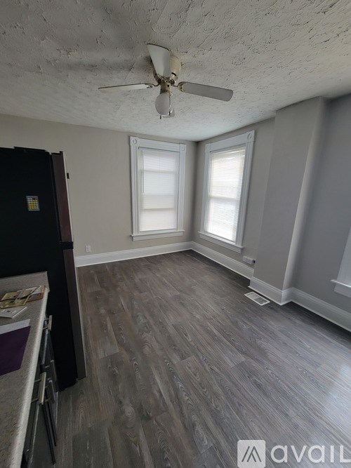 A room with a ceiling fan and a window.