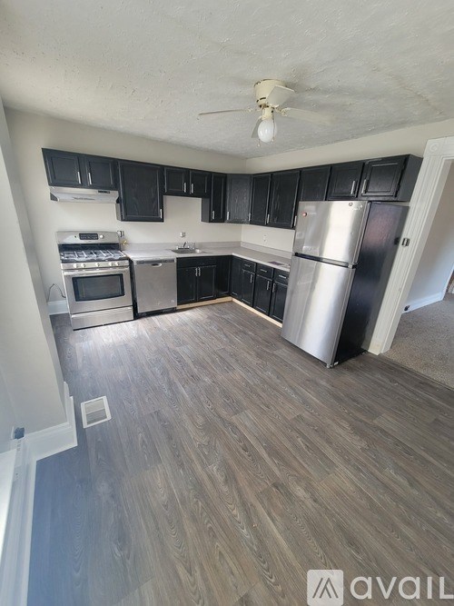A kitchen with a refrigerator, stove, and oven.