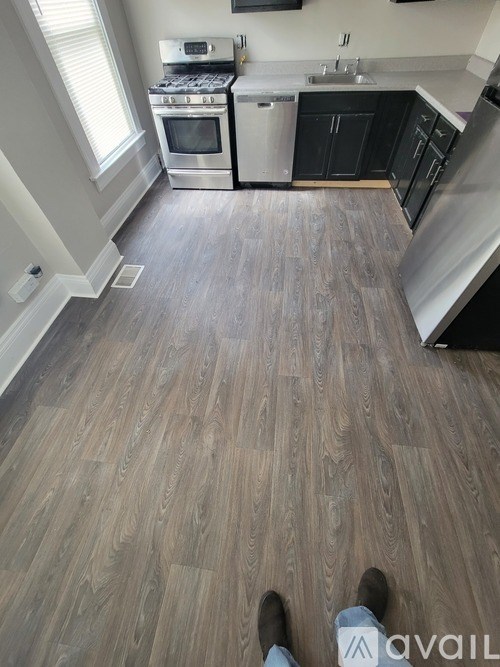 A kitchen with a stove top oven and a dishwasher.