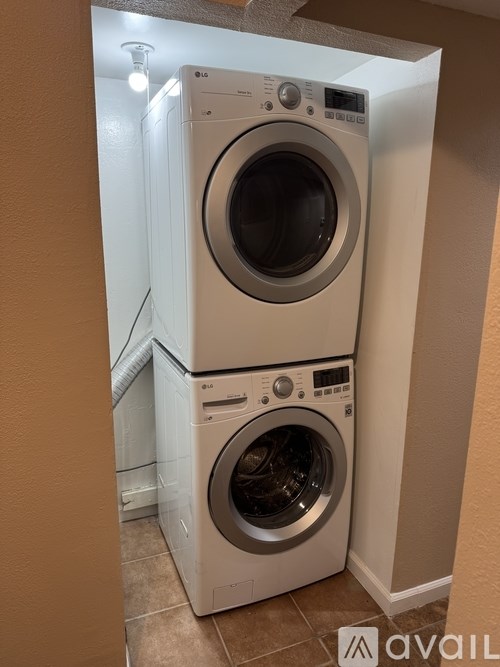 Two front loading washing machines in a laundry room.
