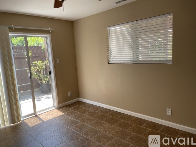 A room with a sliding glass door leading to a backyard.