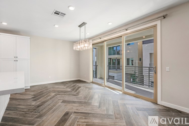A room with a wooden floor and a chandelier.