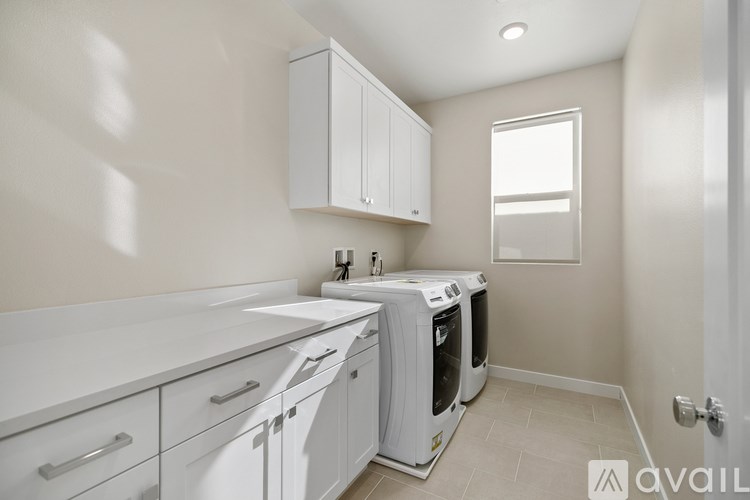 A kitchen with white appliances and cabinets.