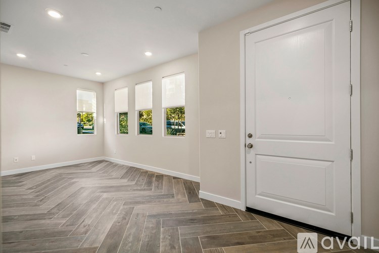 A room with a wooden floor and a white door.
