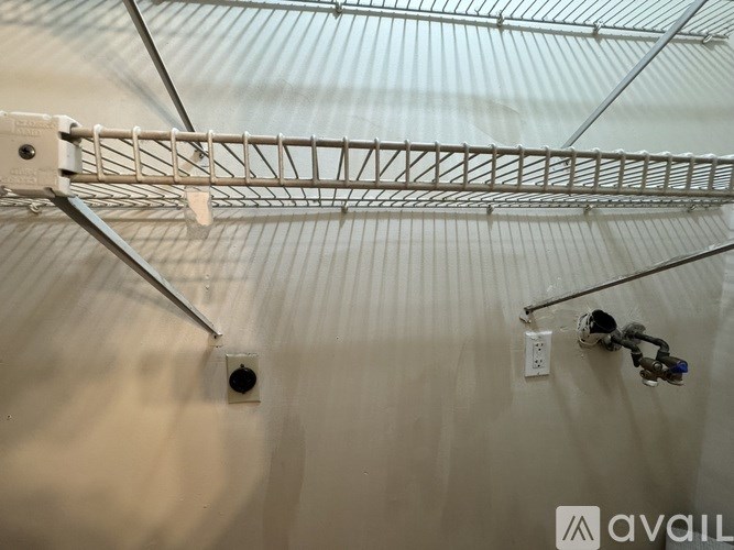 A close up of a metal rack mounted on a wall.