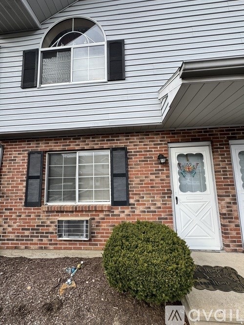 A house with a white door and black shutters.