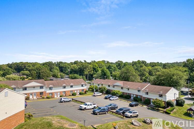 A parking lot in front of a building with a logo that reads "available".