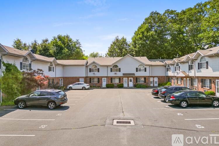 A parking lot with cars and apartment buildings in the background.