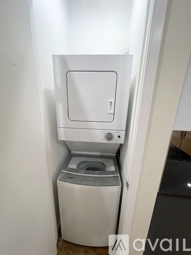 A white washing machine and dryer in a small space.