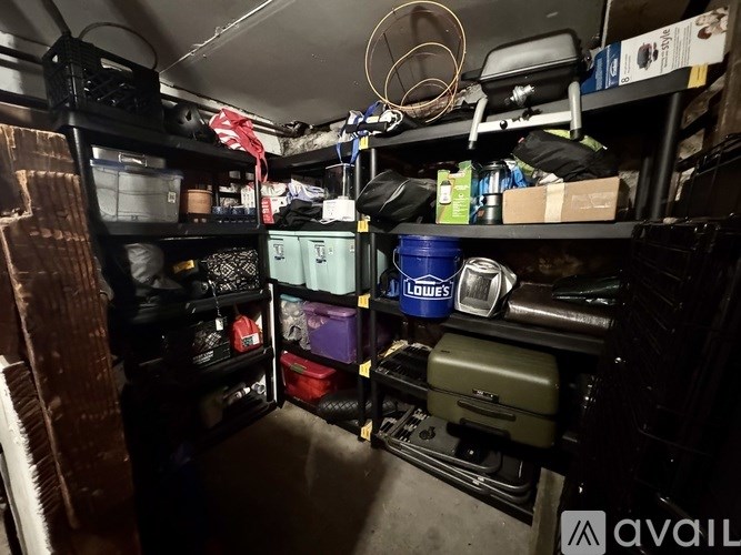 A storage room with various containers and boxes on shelves.