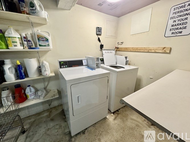 A storage room with a sign on the wall and a shopping cart in the corner.