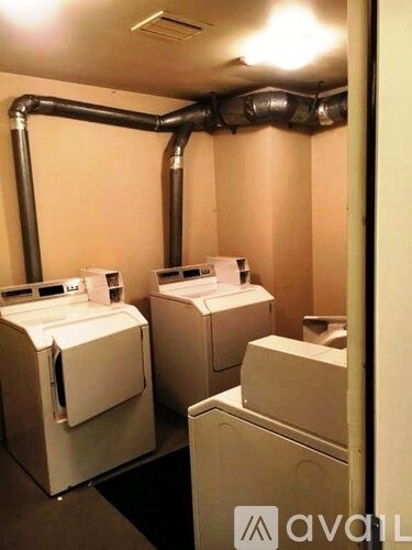 A bathroom with two toilets and a sink.