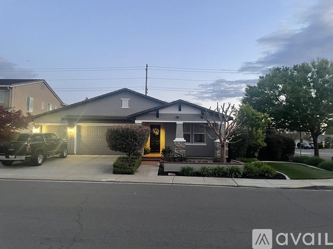 A house with a garage and a driveway in front of it.