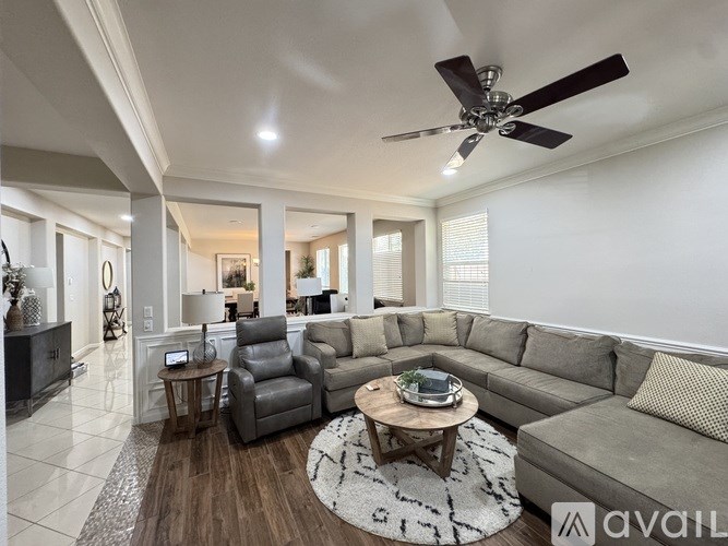 A living room with a grey sofa and a wooden coffee table.