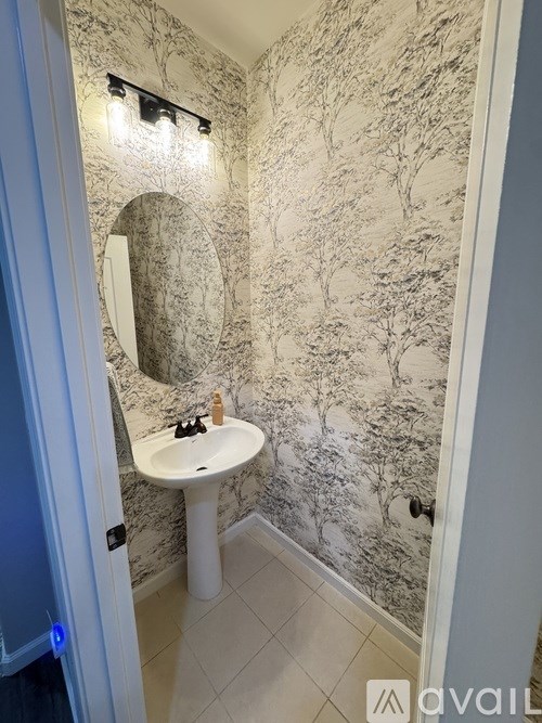 A bathroom with a sink and a mirror.