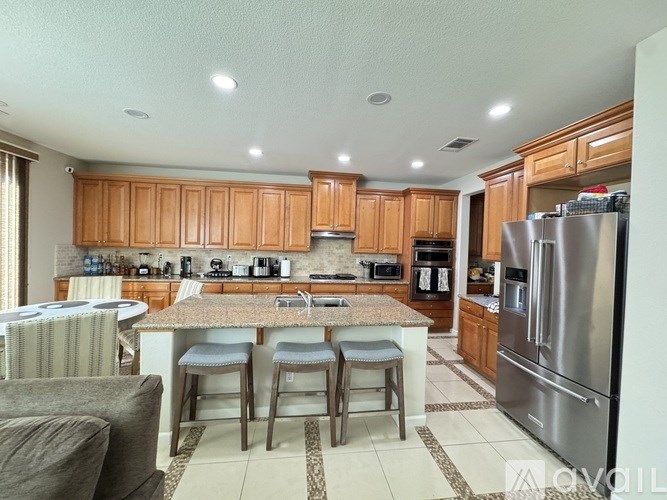 A kitchen with wooden cabinets and a granite countertop.