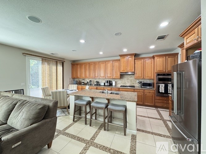 A kitchen with wooden cabinets and a refrigerator.