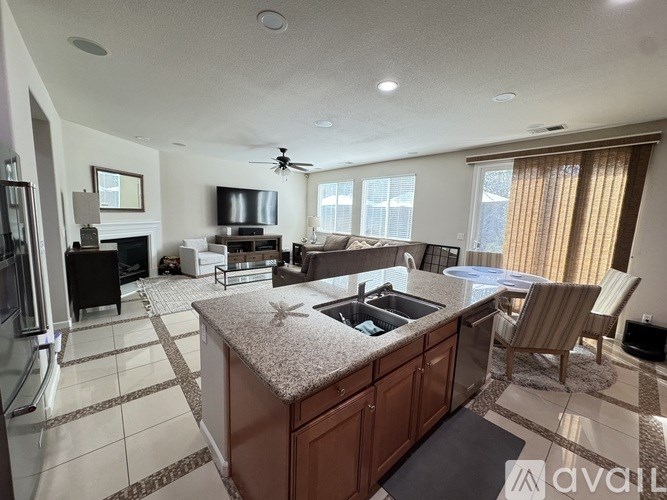 A kitchen with a large island and a dining area.