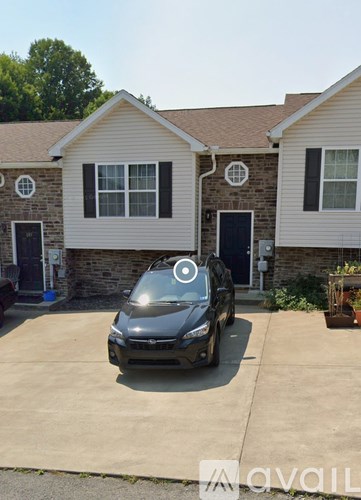 A car is parked in front of a house.