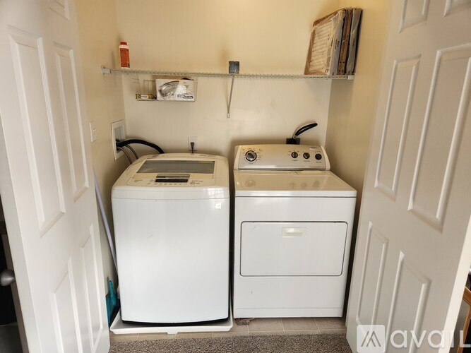 A small laundry room with a washer and dryer.