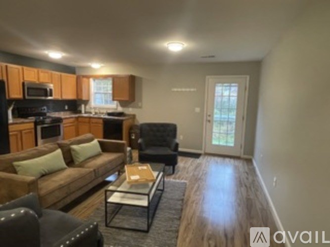 A living room with a couch, chair, and coffee table.